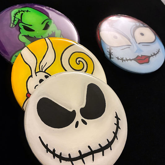 Four Halloween-themed coasters featuring characters of Nightmare Before Christmas with a black background