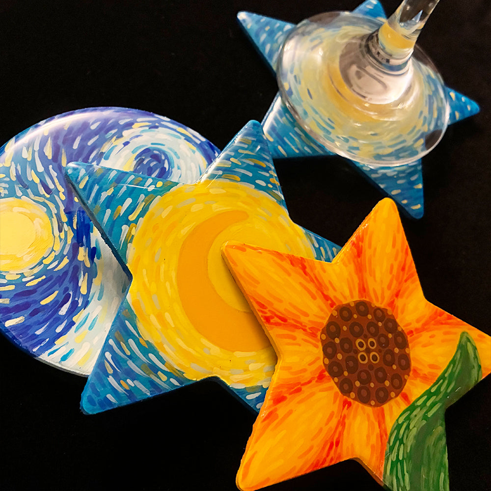 Decorative coasters with artistic designs on a black background