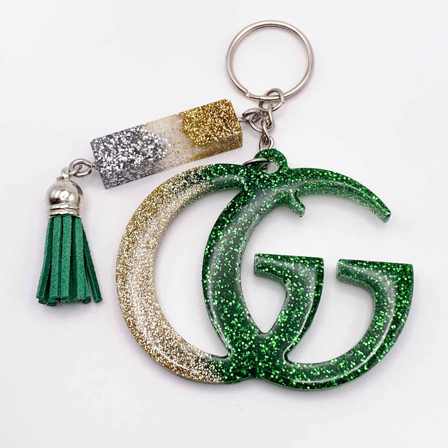 Lee's Art Studio fashion statement resin keychain with silver, gold and green glitter and green tassel front view