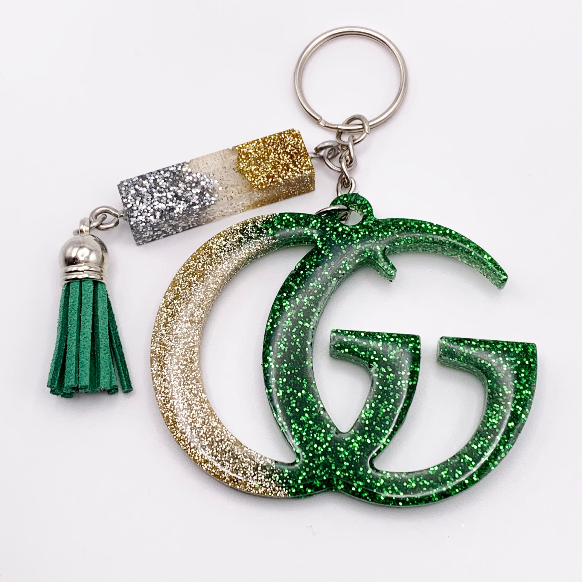 Lee's Art Studio fashion statement resin keychain with silver, gold and green glitter and green tassel front view